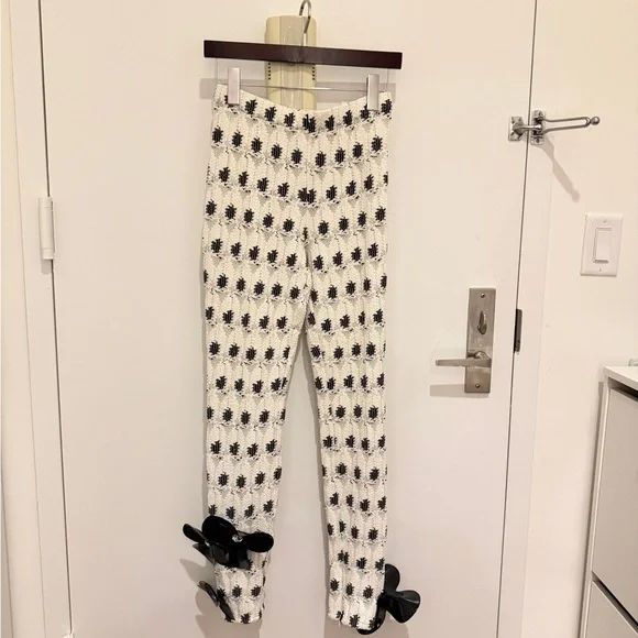 AREA eye crochet knit pants featuring crystal flower applique